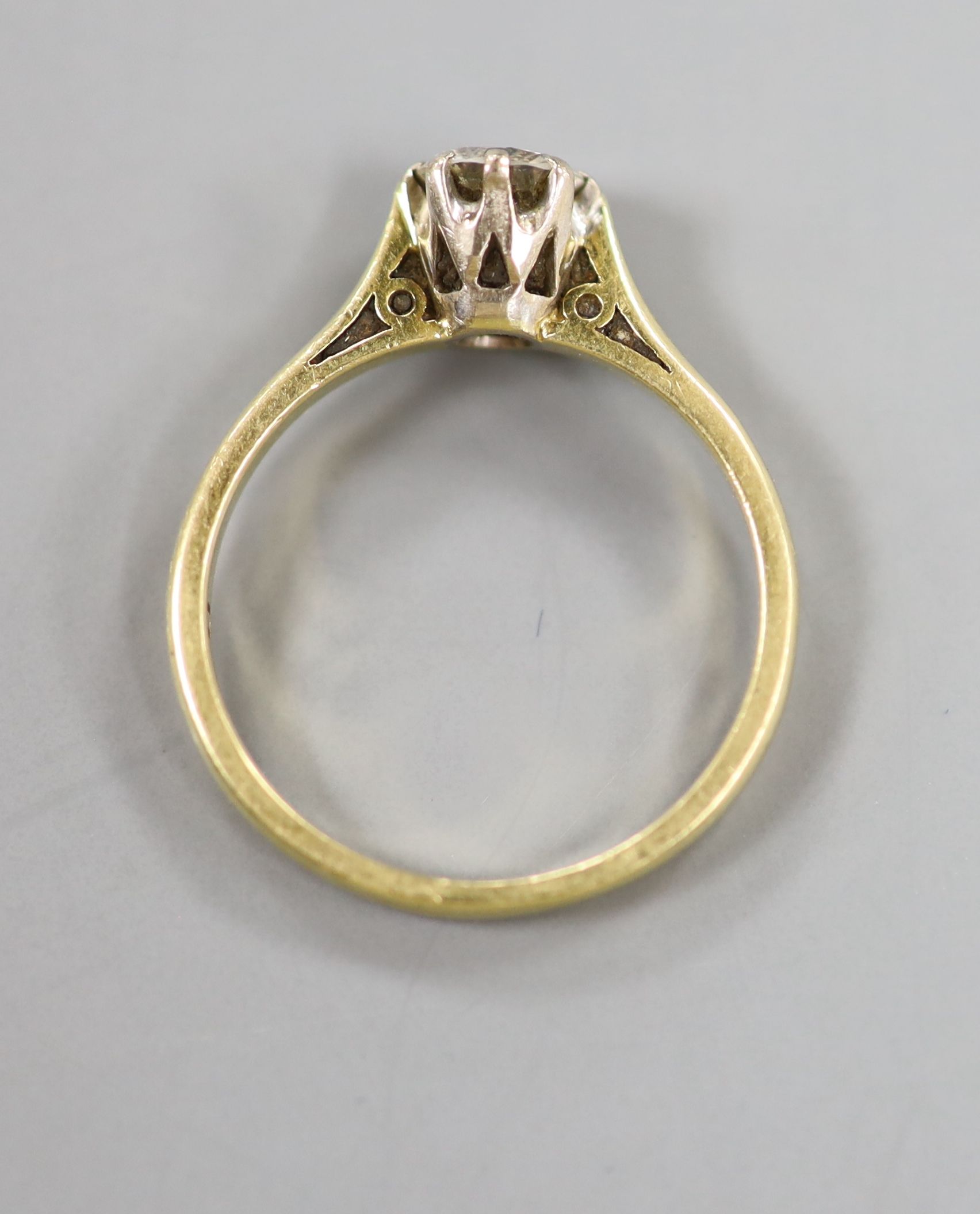 A modern 18ct gold and solitaire diamond ring